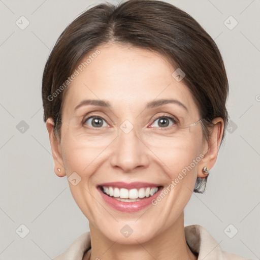 Joyful white adult female with medium  brown hair and grey eyes