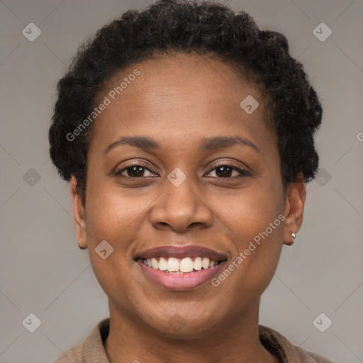 Joyful black young-adult female with short  brown hair and brown eyes