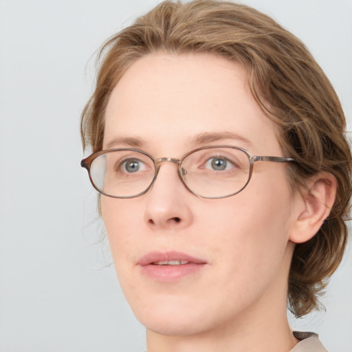 Joyful white adult female with medium  brown hair and blue eyes