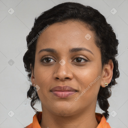 Joyful black young-adult female with long  brown hair and brown eyes