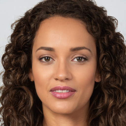 Joyful white young-adult female with long  brown hair and brown eyes