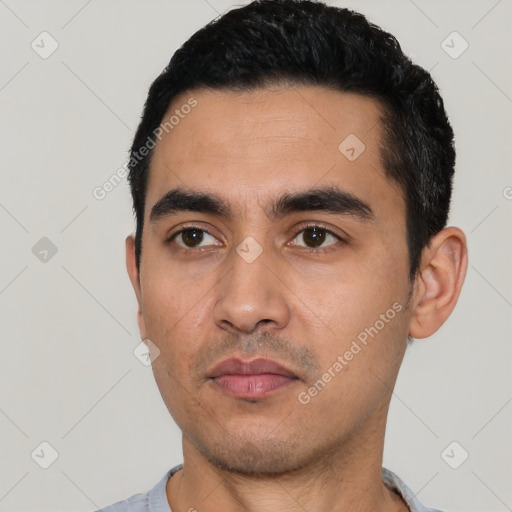 Neutral latino young-adult male with short  black hair and brown eyes