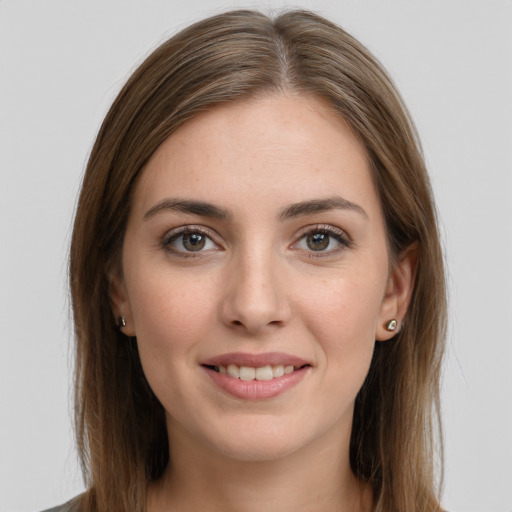 Joyful white young-adult female with long  brown hair and grey eyes