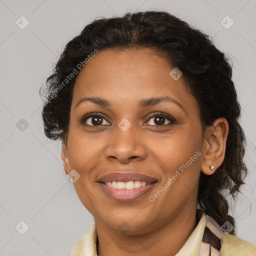 Joyful black adult female with medium  brown hair and brown eyes