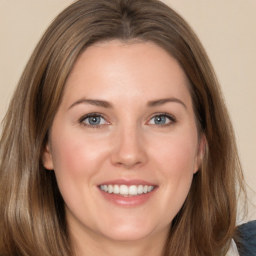 Joyful white young-adult female with long  brown hair and brown eyes