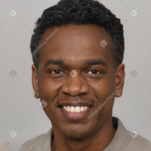 Joyful black adult male with short  black hair and brown eyes