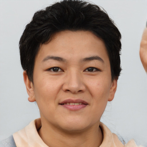 Joyful asian young-adult female with short  brown hair and brown eyes