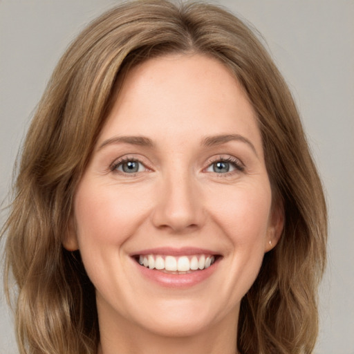 Joyful white young-adult female with medium  brown hair and green eyes