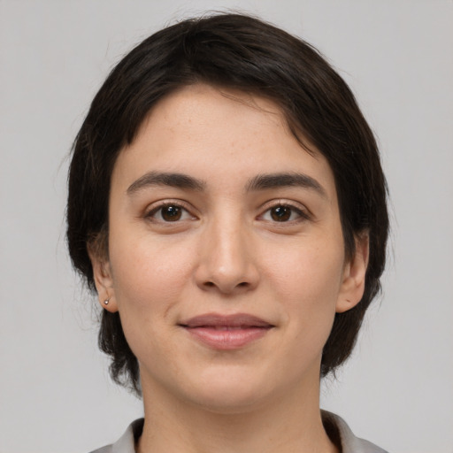 Joyful white young-adult female with medium  brown hair and brown eyes