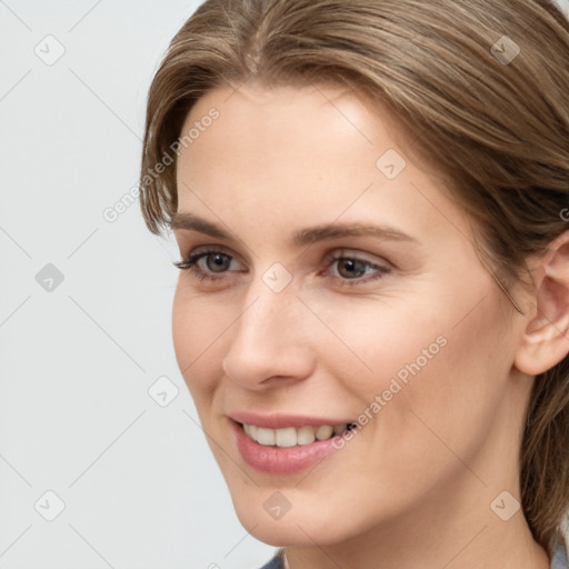 Joyful white young-adult female with medium  brown hair and grey eyes