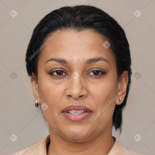 Joyful latino adult female with medium  brown hair and brown eyes