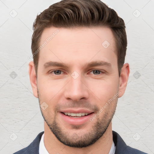 Joyful white young-adult male with short  brown hair and grey eyes