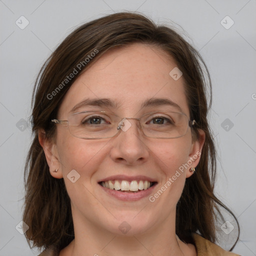 Joyful white adult female with medium  brown hair and blue eyes