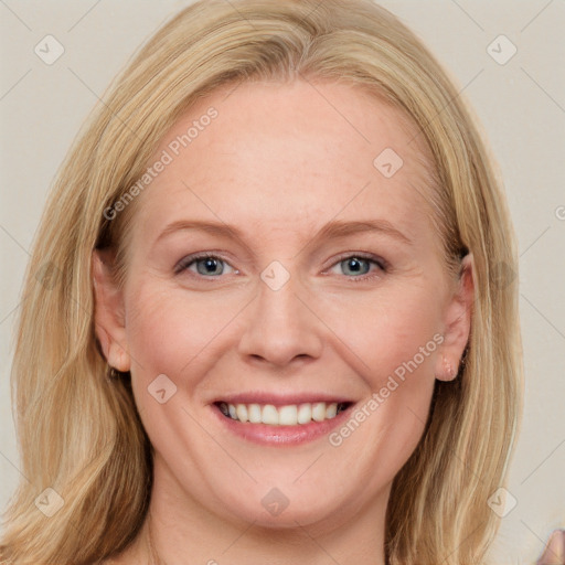 Joyful white adult female with long  brown hair and blue eyes