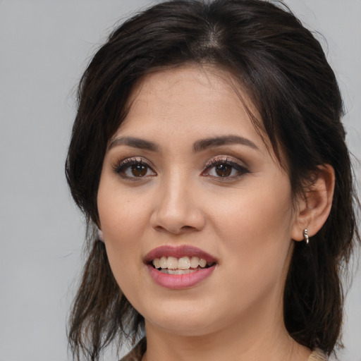 Joyful white young-adult female with medium  brown hair and brown eyes