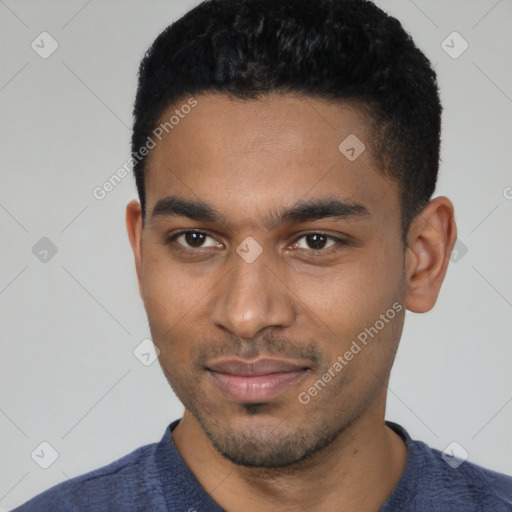 Joyful black young-adult male with short  black hair and brown eyes