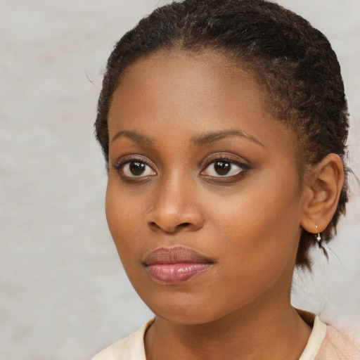 Joyful black young-adult female with medium  brown hair and brown eyes