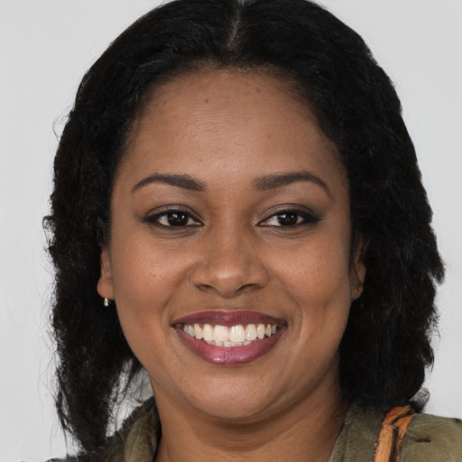 Joyful latino young-adult female with long  brown hair and brown eyes