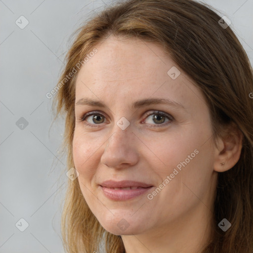 Joyful white adult female with long  brown hair and brown eyes