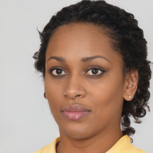 Neutral black young-adult female with medium  brown hair and brown eyes