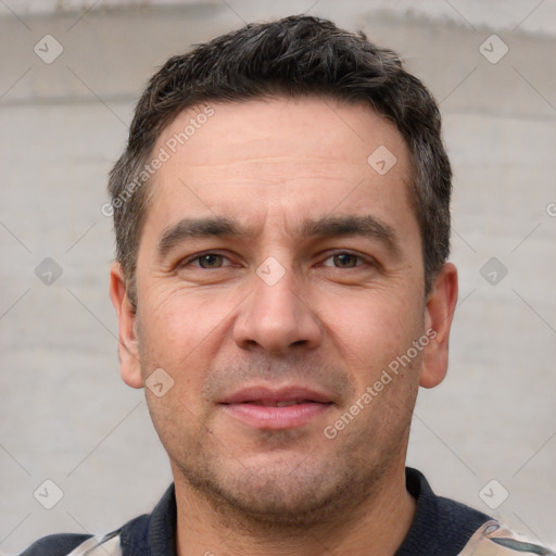 Joyful white adult male with short  brown hair and brown eyes