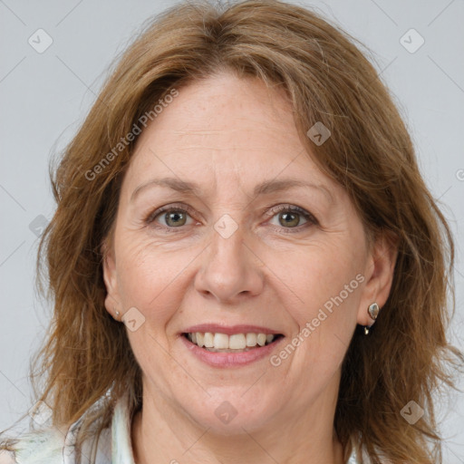 Joyful white adult female with long  brown hair and brown eyes