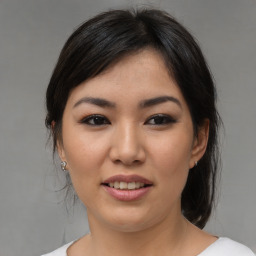 Joyful asian young-adult female with medium  brown hair and brown eyes