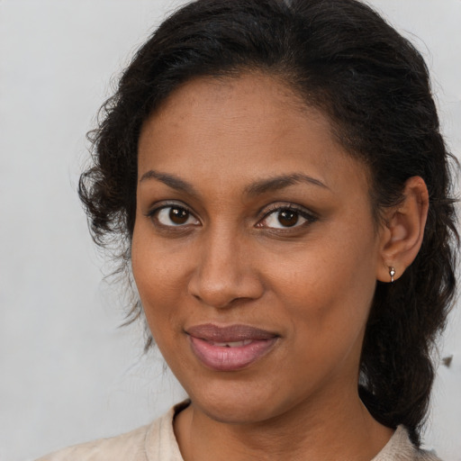 Joyful black young-adult female with medium  brown hair and brown eyes