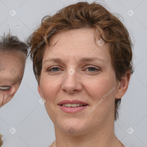 Joyful white adult female with medium  brown hair and blue eyes