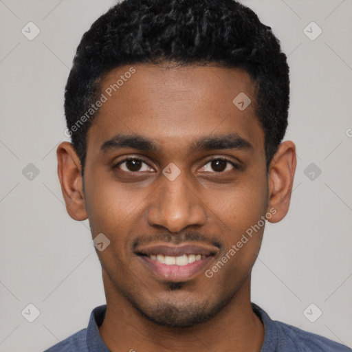 Joyful black young-adult male with short  black hair and brown eyes