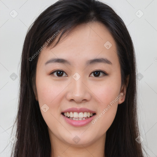 Joyful asian young-adult female with long  brown hair and brown eyes