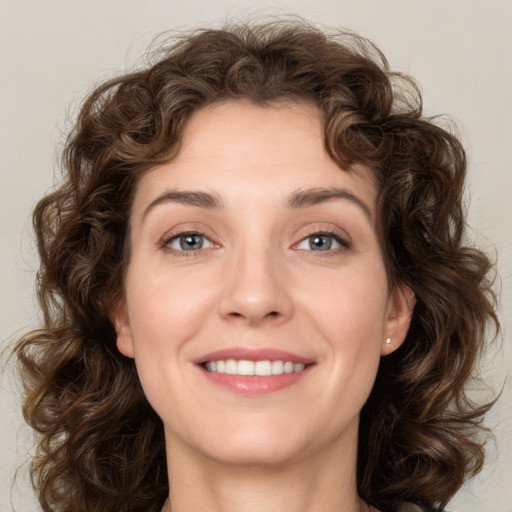 Joyful white young-adult female with medium  brown hair and green eyes