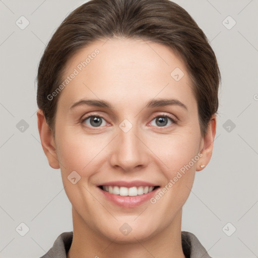 Joyful white young-adult female with short  brown hair and grey eyes