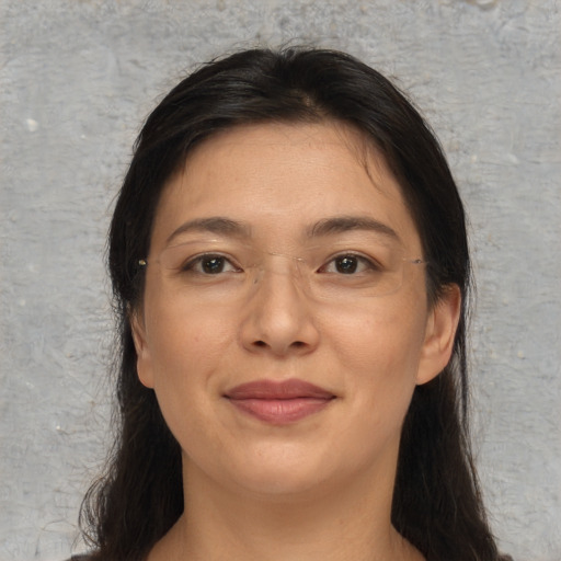Joyful asian adult female with long  brown hair and brown eyes