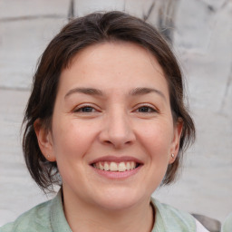 Joyful white adult female with medium  brown hair and brown eyes