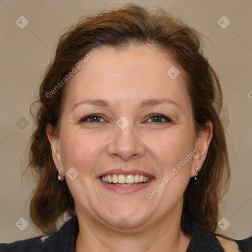 Joyful white adult female with medium  brown hair and brown eyes