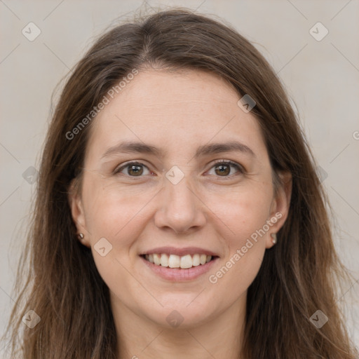 Joyful white adult female with long  brown hair and grey eyes