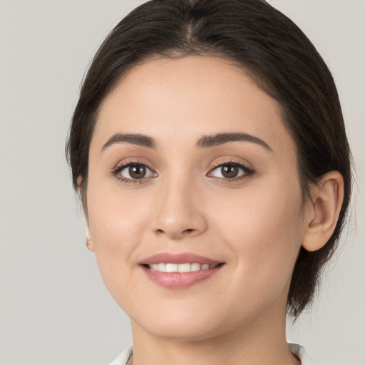 Joyful white young-adult female with medium  brown hair and brown eyes