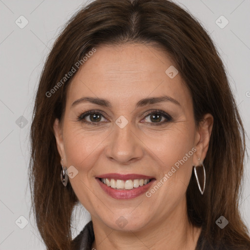 Joyful white adult female with long  brown hair and brown eyes