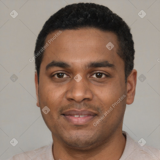 Joyful black young-adult male with short  black hair and brown eyes