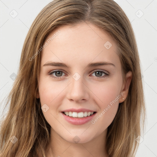 Joyful white young-adult female with long  brown hair and green eyes