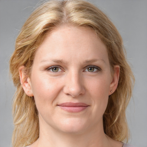 Joyful white young-adult female with medium  brown hair and blue eyes