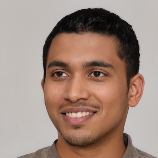 Joyful latino young-adult male with short  black hair and brown eyes