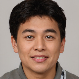 Joyful asian young-adult male with short  brown hair and brown eyes