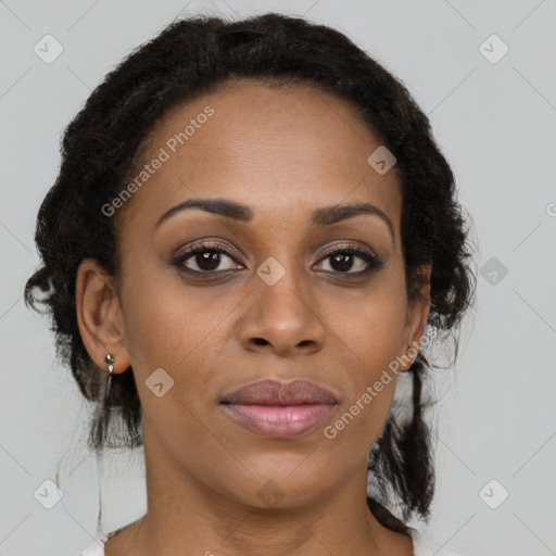 Joyful black adult female with medium  brown hair and brown eyes