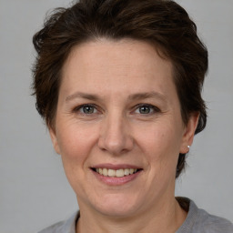 Joyful white adult female with short  brown hair and grey eyes