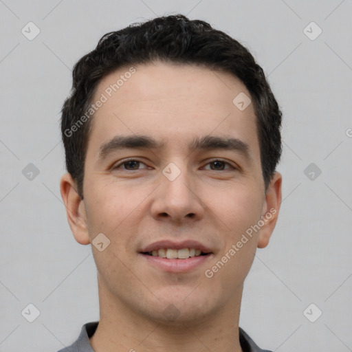 Joyful white young-adult male with short  black hair and brown eyes