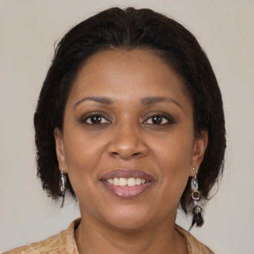 Joyful black young-adult female with medium  brown hair and brown eyes