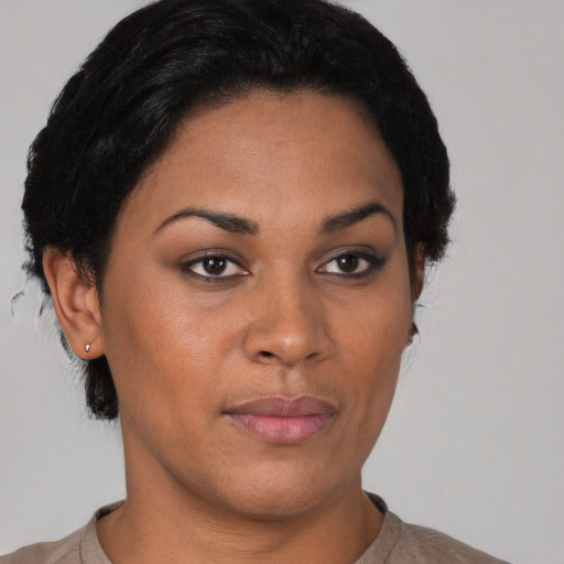 Joyful latino young-adult female with short  black hair and brown eyes