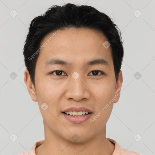 Joyful asian young-adult male with short  black hair and brown eyes